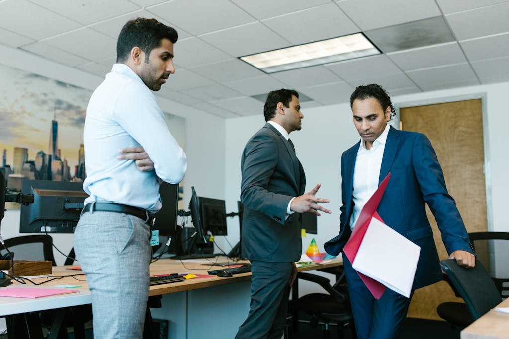 A tense moment captured among colleagues during a business meeting in a modern office setting.
